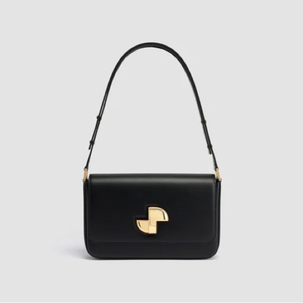 Patou Le Lock Shoulder Bag is a black calf leather